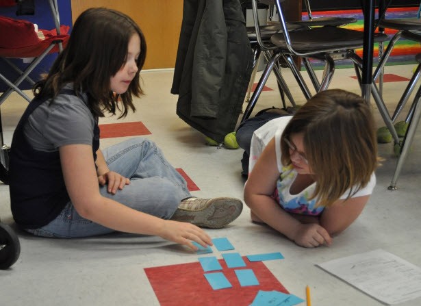 Fifth graders working in math stations.